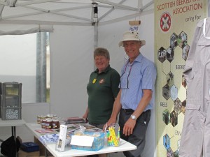 Martin Kay (Fife Beekeepers' Association) and Enid Brown (Association President) face the public in buoyant mood at the Kinross Agricultural Show. It is not unusual for this show to have rain but this year was a pleasant change which helped to keep spirits up!